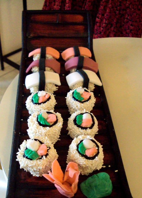 tray of sushi cupcakes on a white table