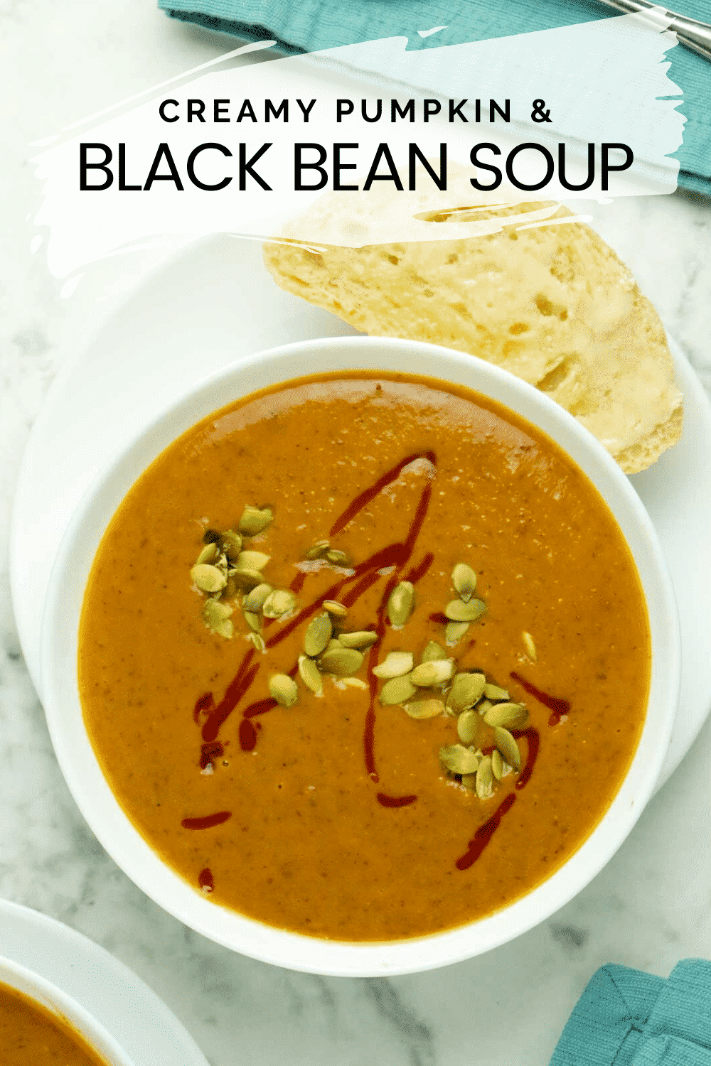 bowl of pumpkin black bean soup with a piece of crusty bread on the side, text overlay