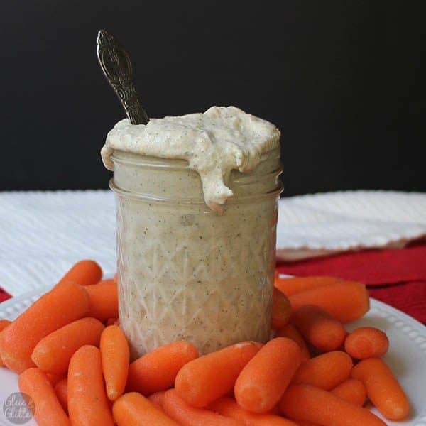 vegan ranch dressing on a table with carrots