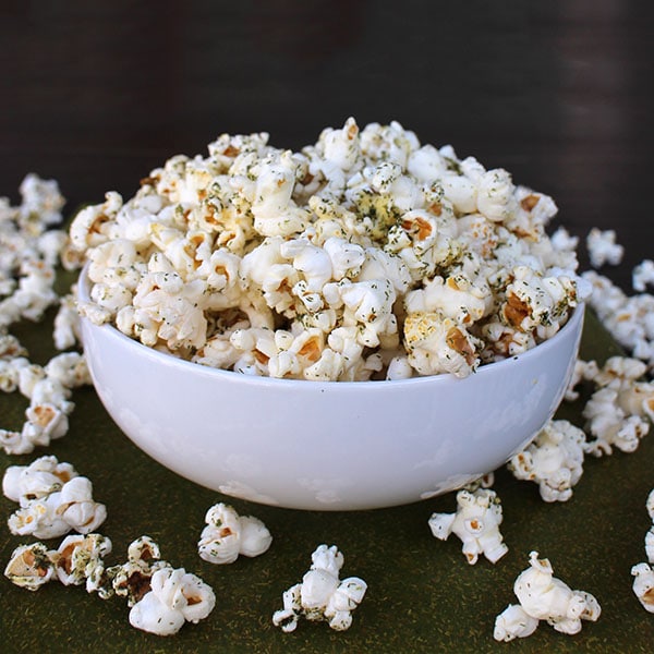 White bowl of popcorn tossed with homemade ranch seasoning