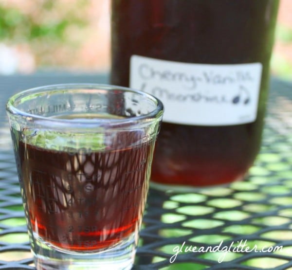 a shot glass of cherry moonshine