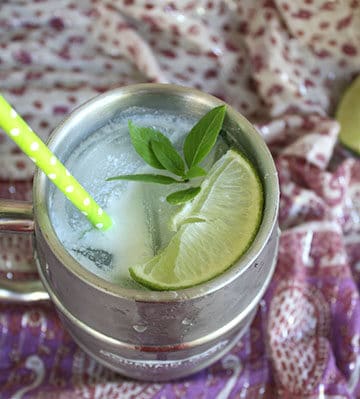 moscow mule in a silver glass with mint and lime