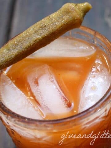 ginger bloody Mary on ice in a glass with pickled jalapeno garnish