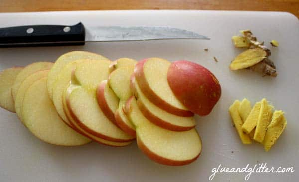 sliced of apple and ginger on a cutting board
