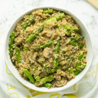 A bowl of  Quinoa Pilaf with mushrooms and asparagus
