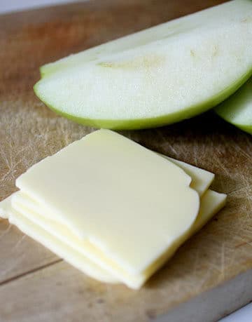 vegan cheese slices next to apple slices