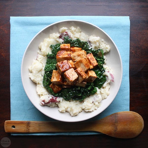 overhead photograph of a mashed potato bowl with kale and BBQ tofu