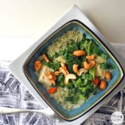 overhead photo of coconut noodle soup wit broccoli, tofu, and cashews