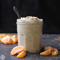 jar of creamsicle overnight oats next to pieces of tangerine