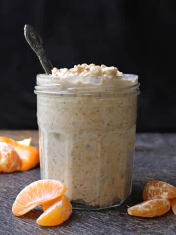 jar of creamsicle overnight oats next to pieces of tangerine