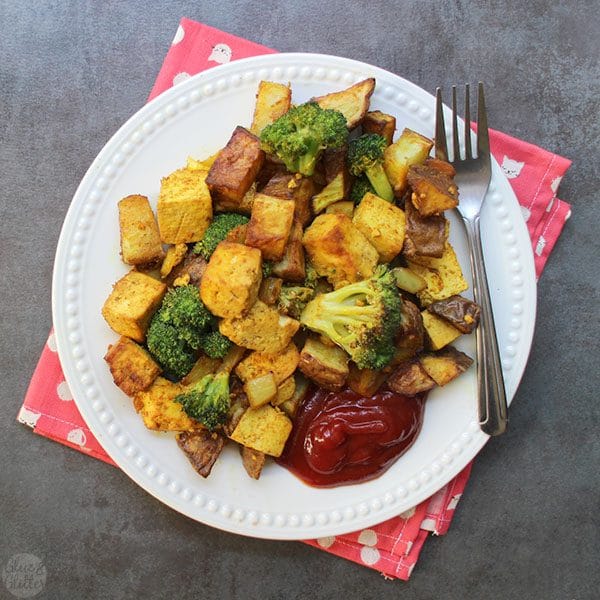 overhead photo of the air fryer tofu scramble with potato and broccoli with a side of ketchup