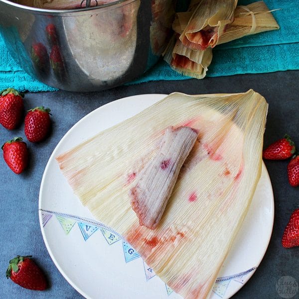 unwrapped strawberry tamale still on the corn husk next to the Instant Pot\'s inner pot