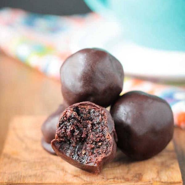 A close up of cherry chocolate truffle with a bite taken out