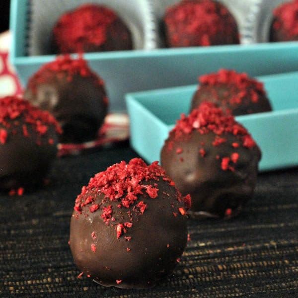 A close up of a raspberry dusted chocolate truffles