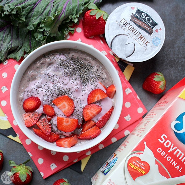 overhead photo of a smoothie bowl with strawberries, chia seeds, and yogurt