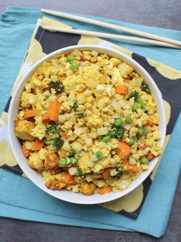 It is so easy to make air fried cauliflower rice in the air fryer! You can follow this recipe exactly or mix-and-match your own veggies to suit your tastes.