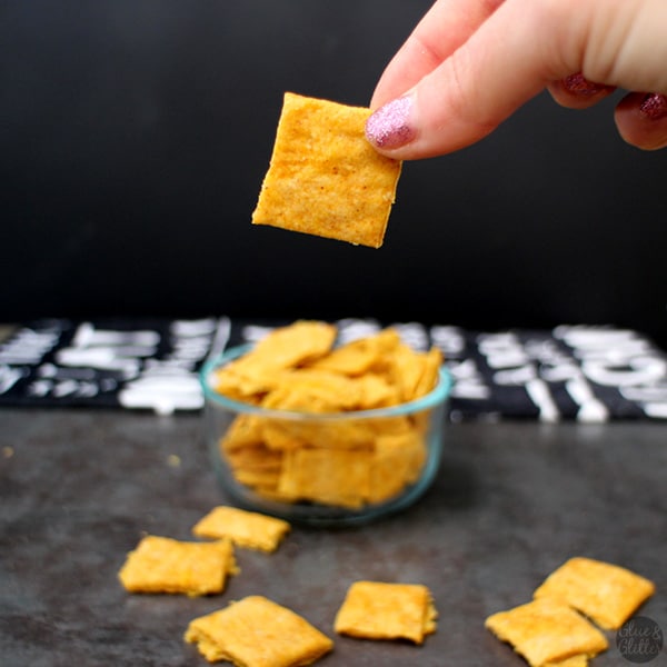 hand holding a vegan cheesy cracker