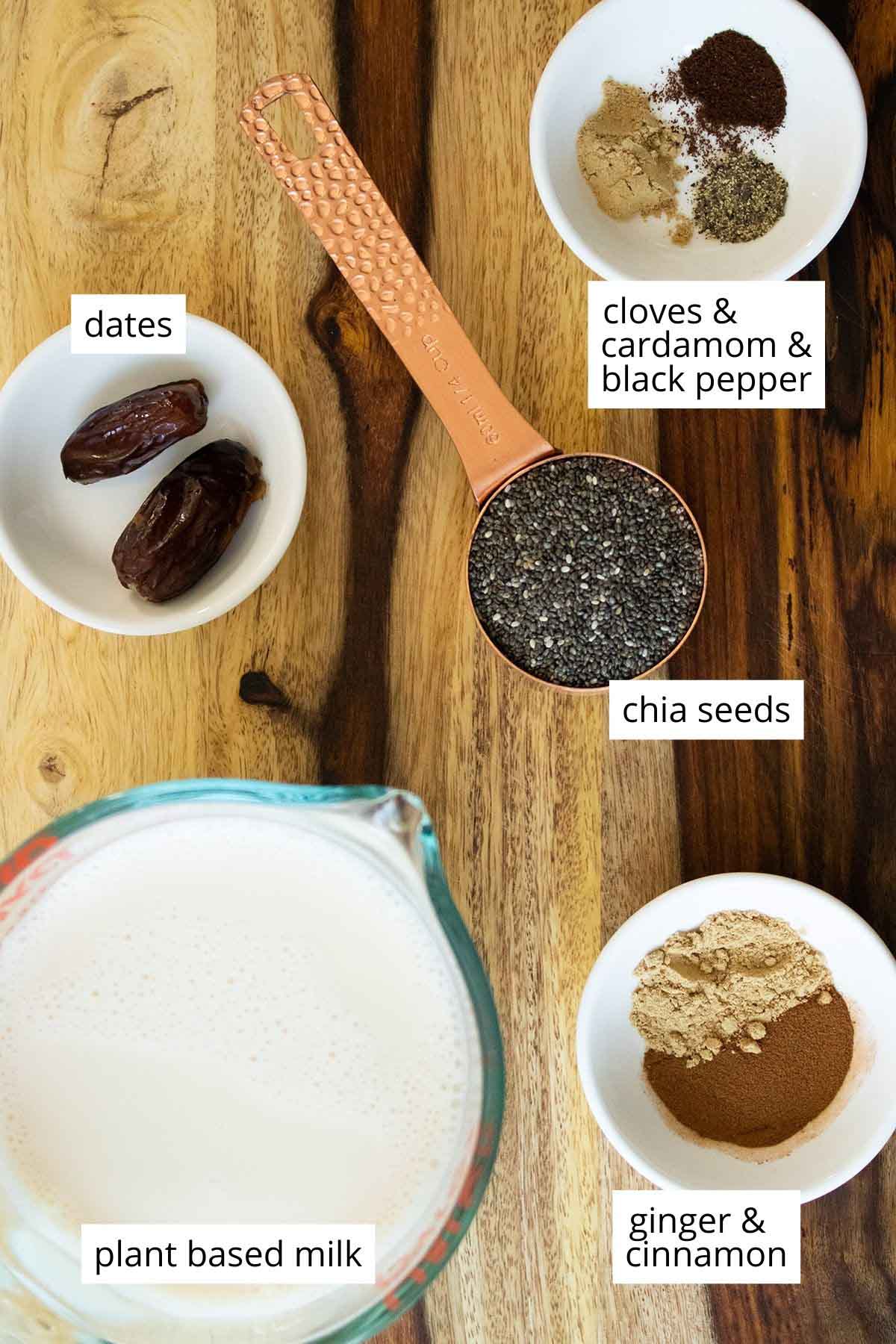 chia seeds, spices, and soy milk in cups on a wooden table