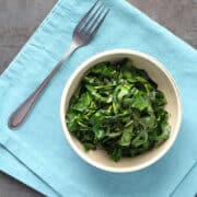 bowl of vegan stovetop collard greens on a blue napkin