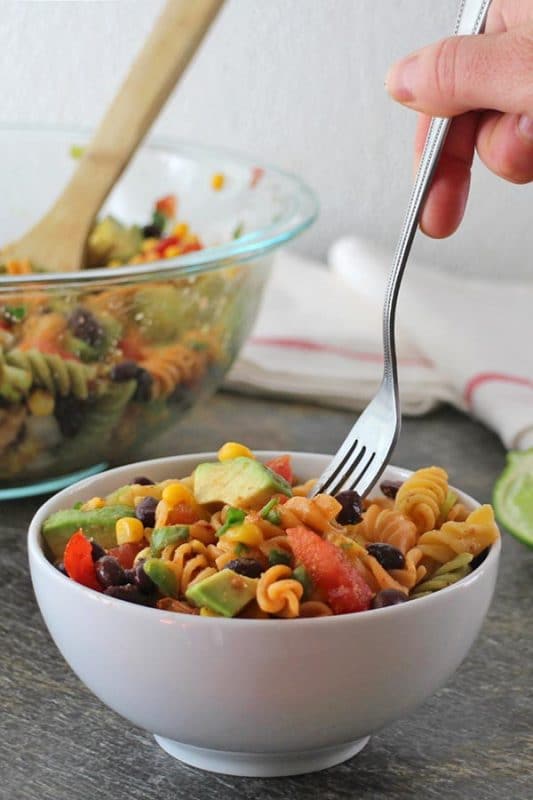 fork taking a bite from a bowl of southwest style pasta salad