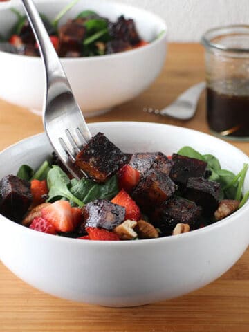 Extra firm, pressed tofu marinated and baked in Maple-Balsamic Sauce is the star of this flavorful Strawberry Spinach Salad.