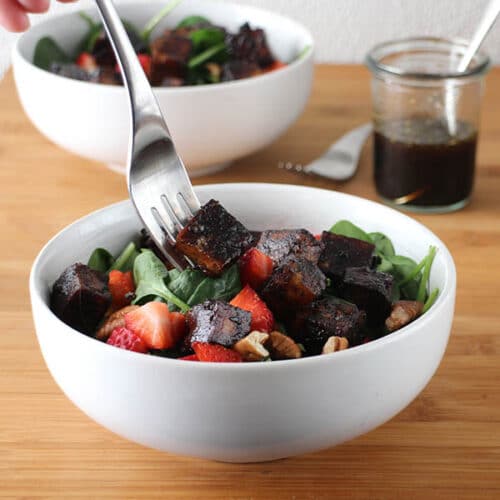 Extra firm, pressed tofu marinated and baked in Maple-Balsamic Sauce is the star of this flavorful Strawberry Spinach Salad.