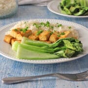 air fryer baby bok choy on a white plate with tofu and rice