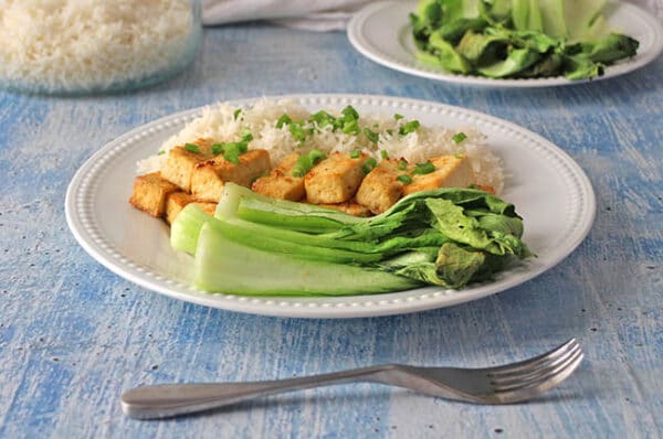 air fryer baby bok choy on a white plate with tofu and rice