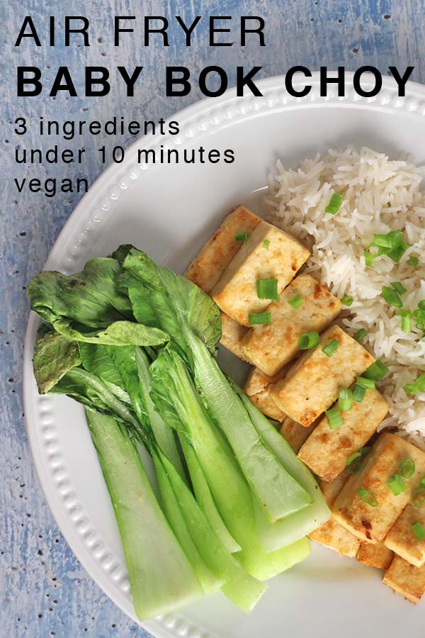 air fryer baby bok choy on a white plate with tofu and rice with a text overlay