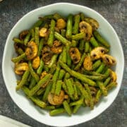 air fryer green beans with mushrooms in a white serving bowl