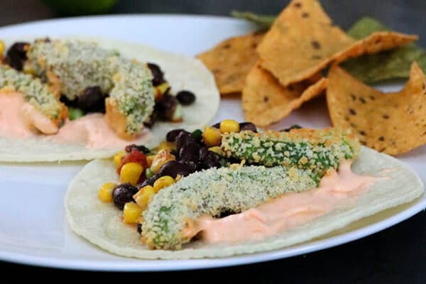 avocado tacos on a plate with corn chips