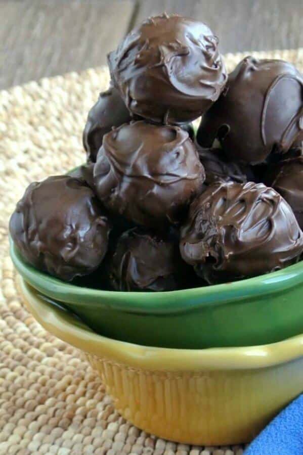 a bowl overflowing with chocolate peanut butter balls