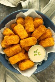 buffalo tofu nuggets in a serving bowl with creamy dipping sauce