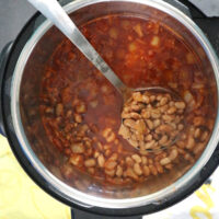 serving pinto beans with a ladle from the Instant Pot