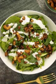 green salad with creamy dressing and vegan bacon bits on top