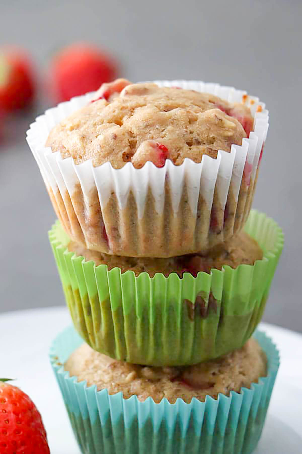 3 vegan strawberry muffins in a stack