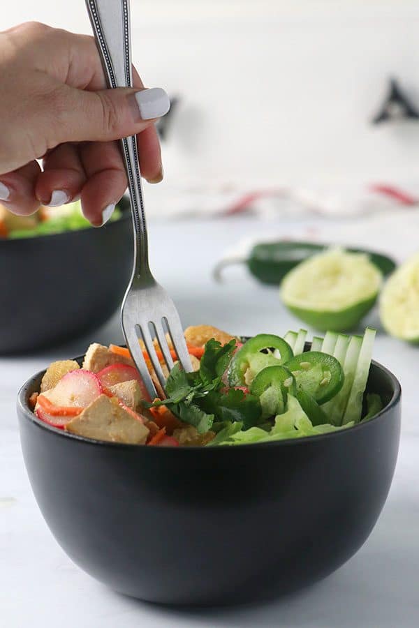 fork taking a bite from a bowl of banh mi salad