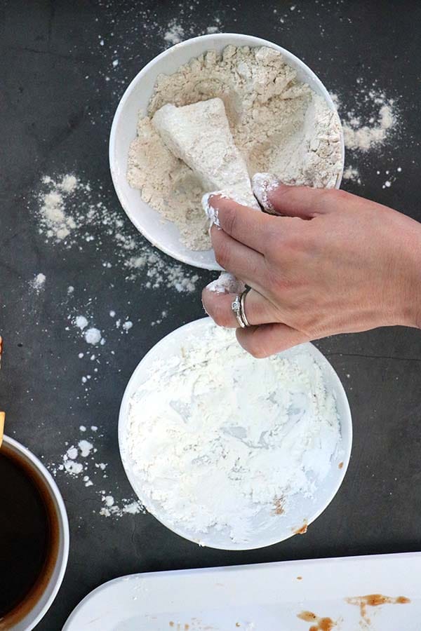 breading the tofu in cornstarch and flour