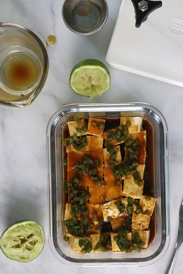 tofu marinating in a glass dish on the table