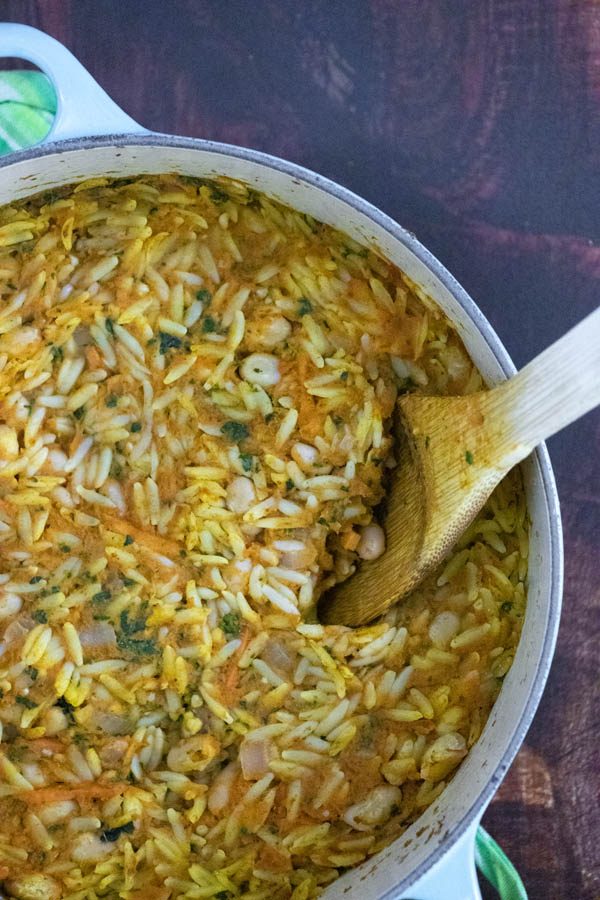 close-up of pumpkin baked orzo in a Dutch oven