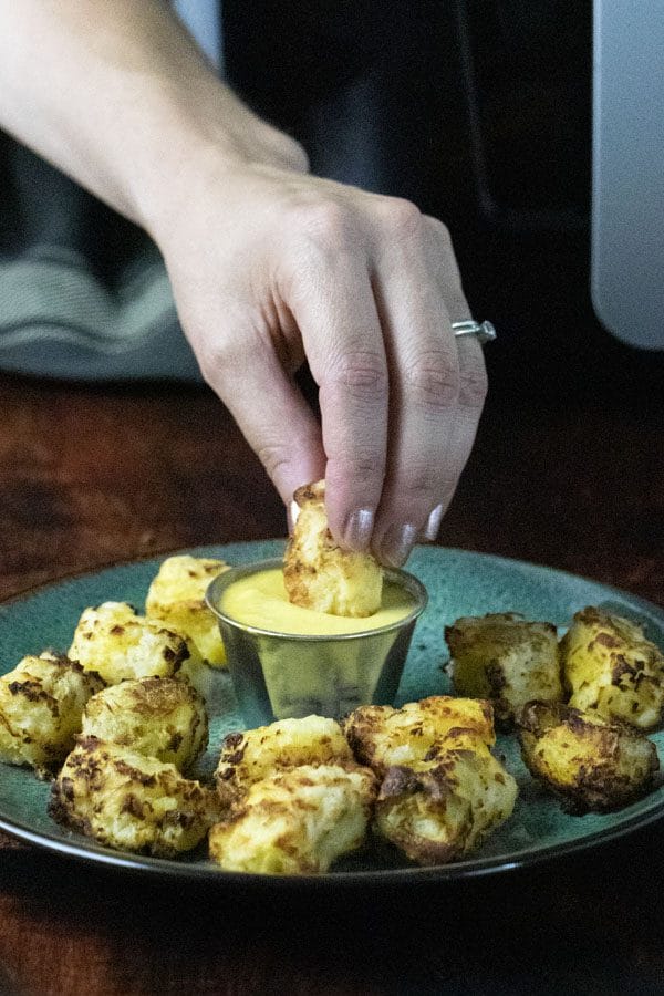 dunking a tot into mustard sauce