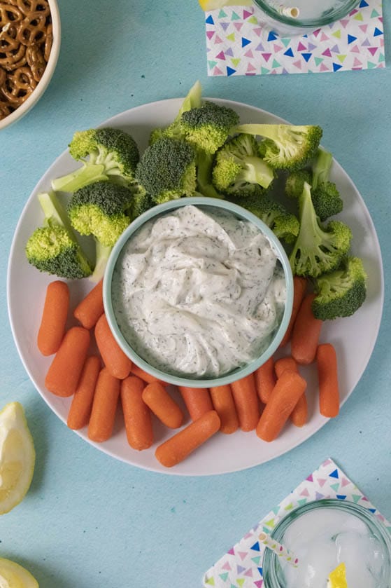 overhead photo of party spread with vegan sour cream dip in the center