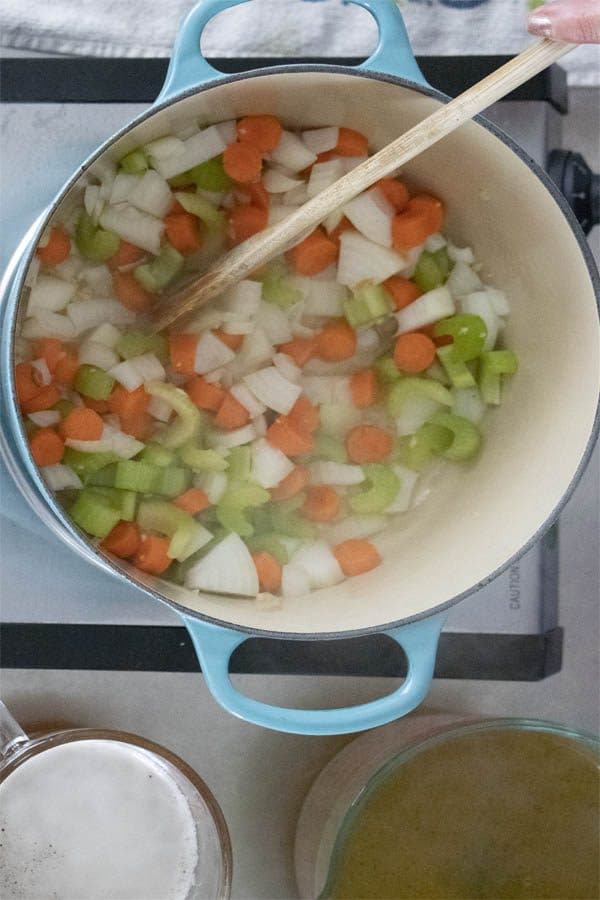 sauteing carrots, onion, celery, and garlic in a Dutch oven