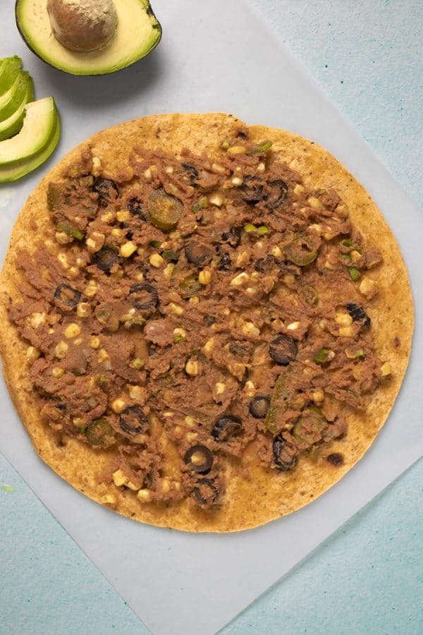 vegan rollup filling spread onto a large tortilla