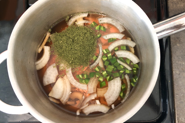 pickled okra brine ingredients in a saucepan before stirring or heating