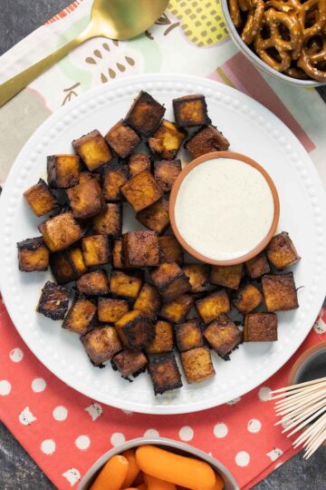 sriracha tofu bites on a white plate with ranch to dip