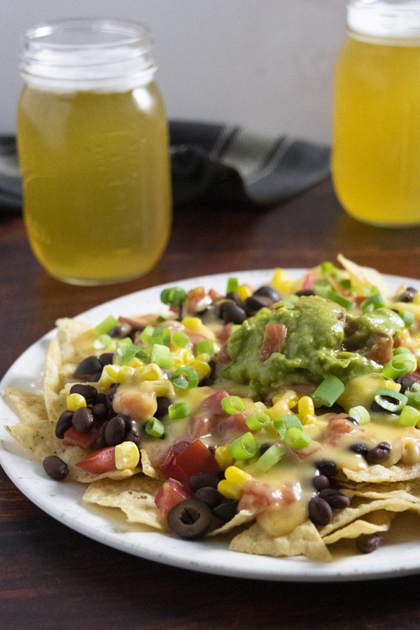 a plate of loaded vegan nachos that are sure to help you stick with your vegan diet!