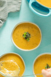 bowls of Eggplant Tomato Soup on a blue table