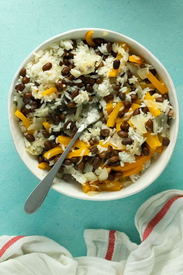 serving bowl of beans and rice with orange bell peppers