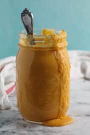 jar of coconut curry sauce with some sauce running down the side of the jar